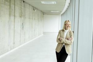 Business woman standing in the office corridor photo