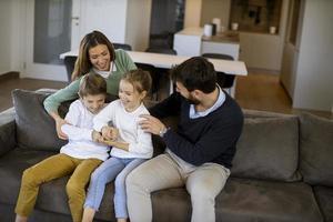 Siblings fighting over TV remote control at home photo