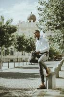 Young African American businessman waitng for a taxi on a street photo