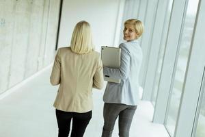 Business women walking in the office corridor photo