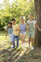 Group of asian and caucasian kids having fun in the park photo