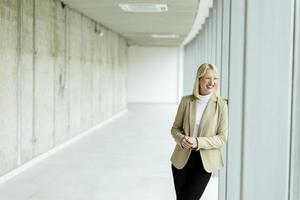 Business woman standing in the office corridor photo