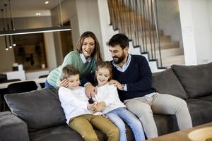 Siblings fighting over TV remote control at home photo