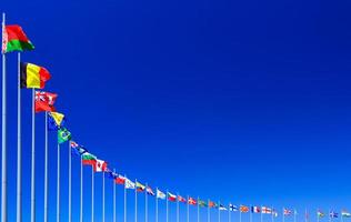 Flags against blue sky, copyspace photo