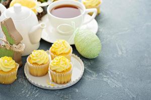 Lemon cupcakes with yellow frosting photo