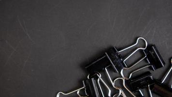 a black paper clip on a black background photo