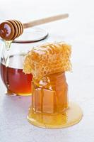 Jar of honey and honeycomb photo