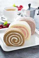 Variety of cake rolls with coffee photo