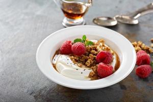 Yogurt bowl with raspberry and maple syrup photo