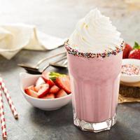 Strawberry milkshake with whipped cream photo