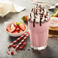 Strawberry milkshake with whipped cream photo