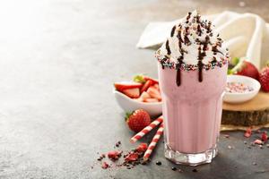 Strawberry milkshake with whipped cream photo