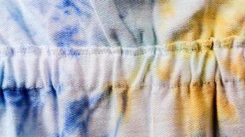 white cloth texture with yellow and blue patterns as background photo