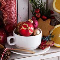 Tea cup with decorations, cookies and oranges for Christmas photo