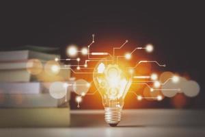 Light bulbs and books. Concept of reading books, knowledge, and searching for new ideas. Innovation and inspiration, Creativity with twinkling lights, the inspiration of ideas. photo