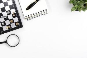 top view of modern white office desk with computer keyboard, blank notebook page and other equipment on white background. Workspace concept, workspace management style, business design space with copy photo