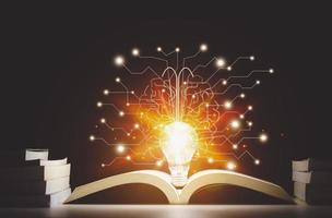 Light bulbs and books. Concept of reading books, knowledge, and searching for new ideas. Innovation and inspiration, Creativity with twinkling lights, the inspiration of ideas. photo