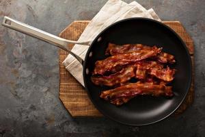 Cooked bacon on a skillet photo