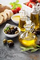 Olive oil in vintage bottles and italian cuisine ingredients photo