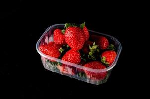 Strawberries on black background photo