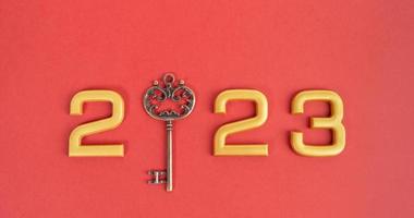 Number 2023 with key on red background. Happy New Year and Christmas 2023 concept. photo