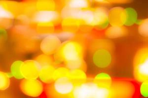 Blur gold, green, and red color bokeh background. Blur abstract background for Christmas day. Light with a beautiful pattern of round bokeh. Orange festive light in the night. Flare lights at night. photo