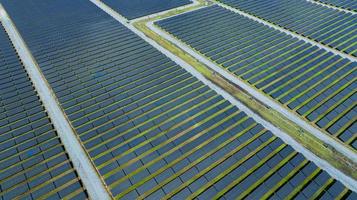 Aerial view of solar farm. Solar power for green energy. Sustainable resources. Solar cell panels use sun light as a source to generate electricity. Photovoltaics or PV. Sustainable renewable energy. photo