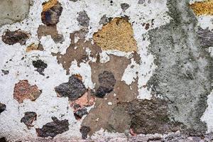 Detailed close up view on aged concrete walls with cracks and lots of structure photo