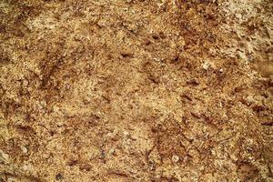 Detailed close up view on a brown sand ground texture photo