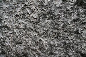 Detailed view on aged concrete walls with cracks and a lot of structure in high resolution photo