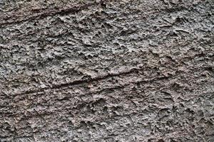 Detailed view on aged concrete walls with cracks and a lot of structure in high resolution photo