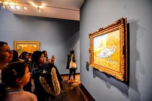 Unidentified people and artwork in the Musee d Orsay in Paris, France, circa October 2022 photo