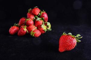 Strawberries on black background photo