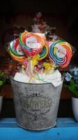 Colorful kid lollipop candy in a can bucket. photo