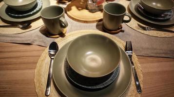 Dinning table set at home, tableware, glasses, spoon and fork. photo