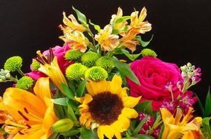 A colorful flower arrangement against a black background. photo