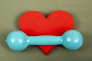 heart-related physical activity risks represented by a dumbbell weight and a heart shape photo