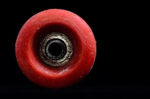 Old Vintage Consumed Skate Wheel on black background photo