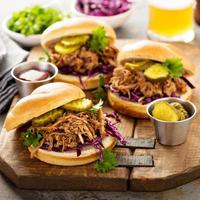 Pulled pork sandwiches with cabbage and pickles photo