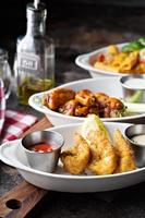 Variety of appetizers with fried shrimp and wings photo