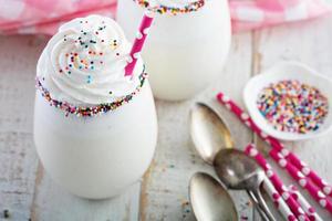 Vanilla milkshake with whipped cream and sprinkles photo