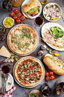 Big dinner with pizza and sandwiches photo