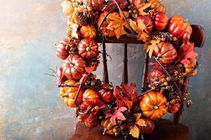 Festive autumn wreath with pumpkin and fall leaves photo