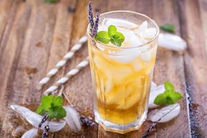 Lavender iced tea in tall glass photo