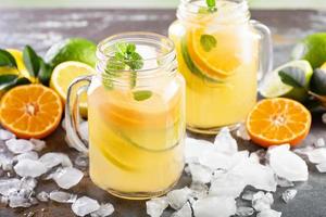 Citrus fruit lemonade in mason jars photo