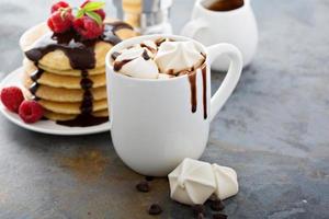 Hot chocolate with marshmallows and little meringues photo