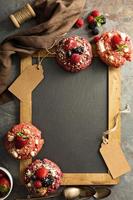 Variety of donuts around a chalkboard photo