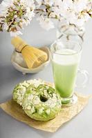 Matcha and white chocolate donuts with tea photo