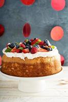 Angel food cake with whipped cream and berries photo