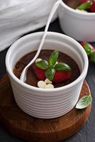 Chocolate pudding with raspberries and basil photo